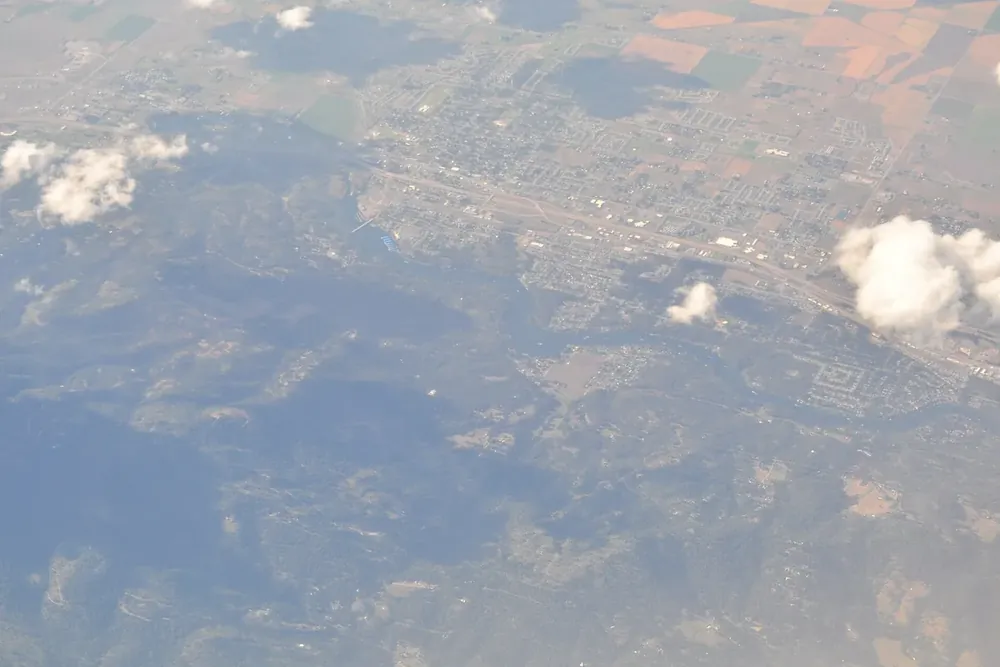 Aerial view of Post Falls, Idaho with the Spokane River bending past neighborhoods and farm fields